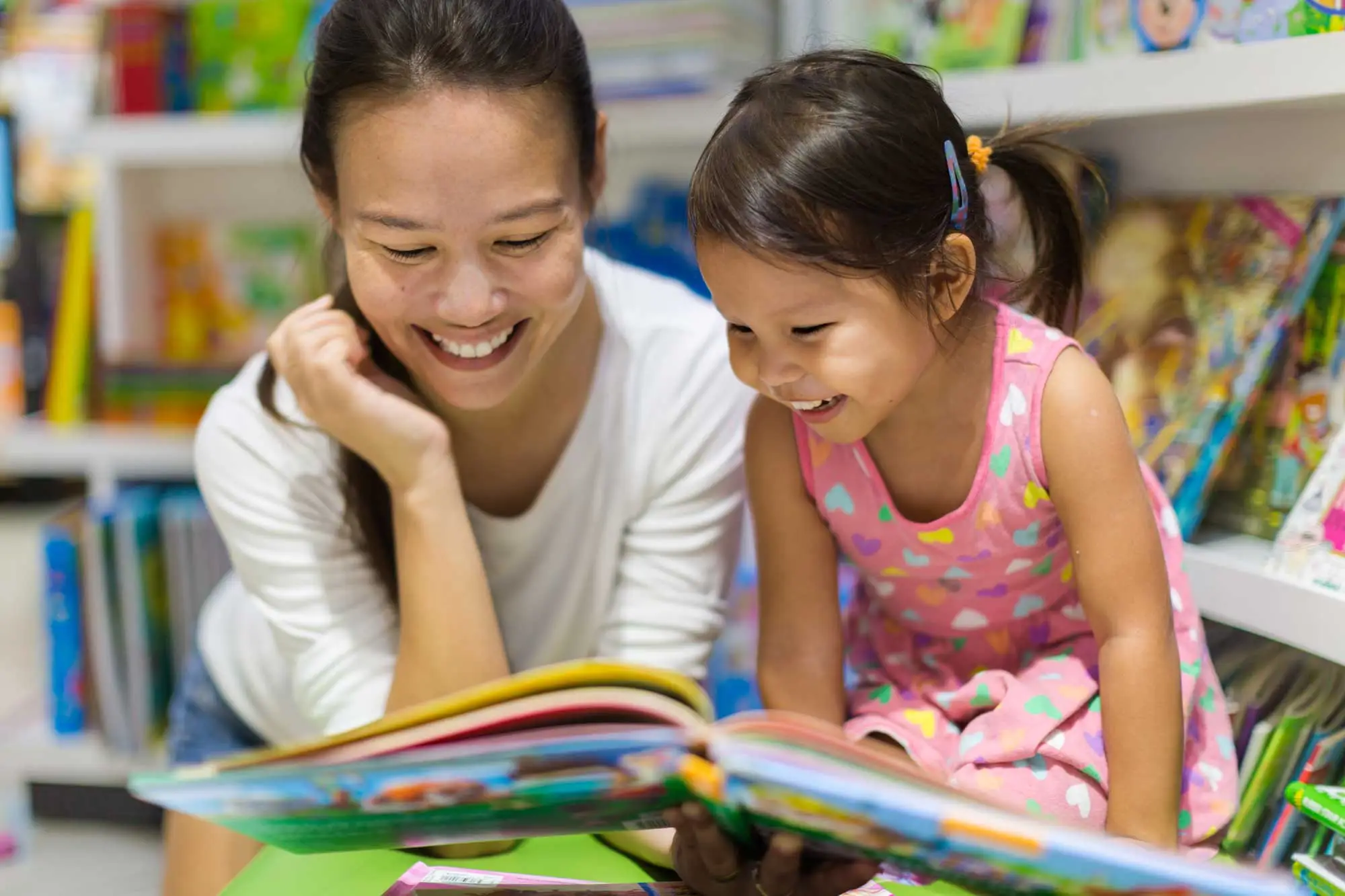 Young child smiling while engaged in an early learning activity at a child care center