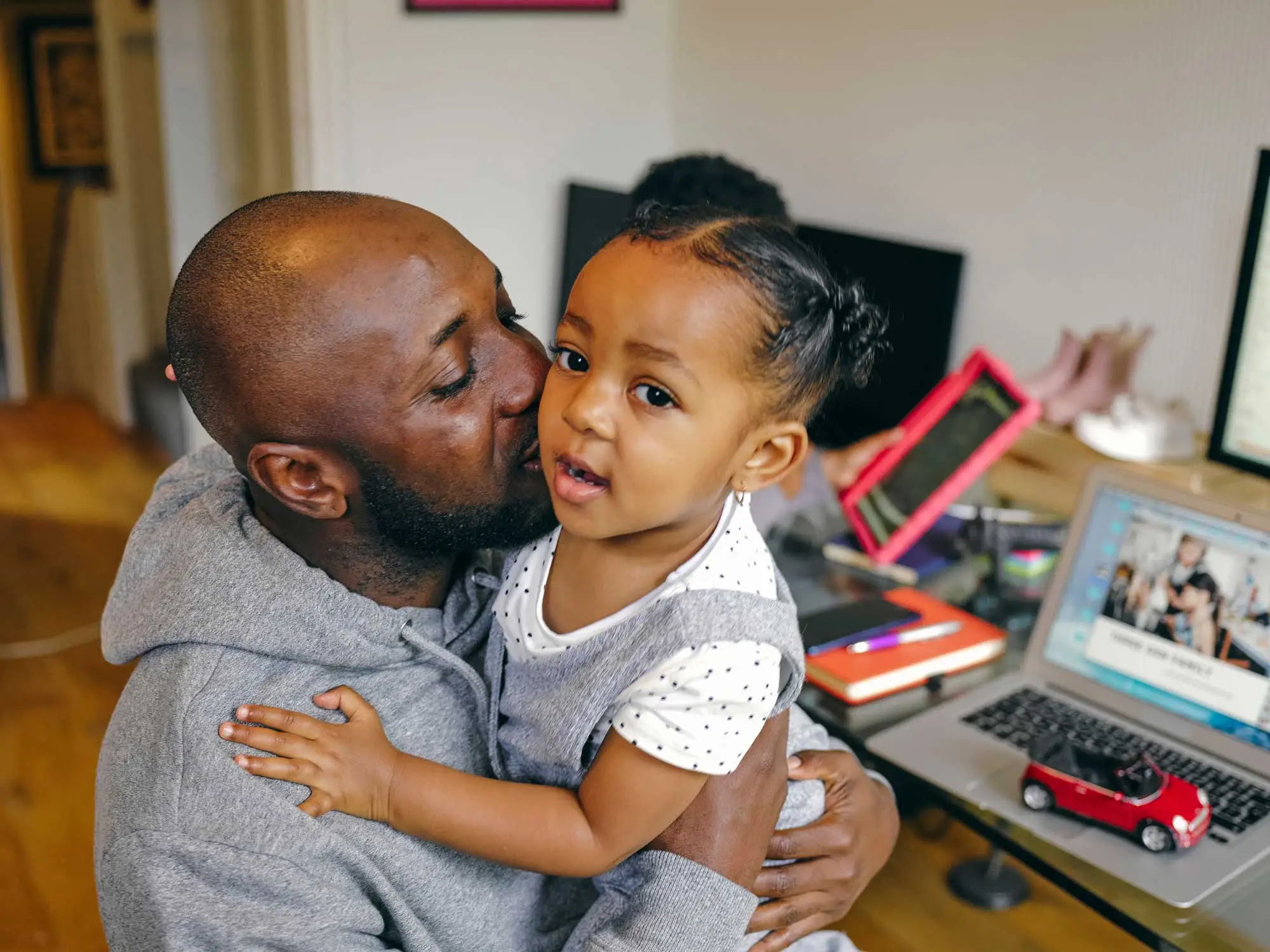 Parent and child together, representing Travis County families served by child care support programs